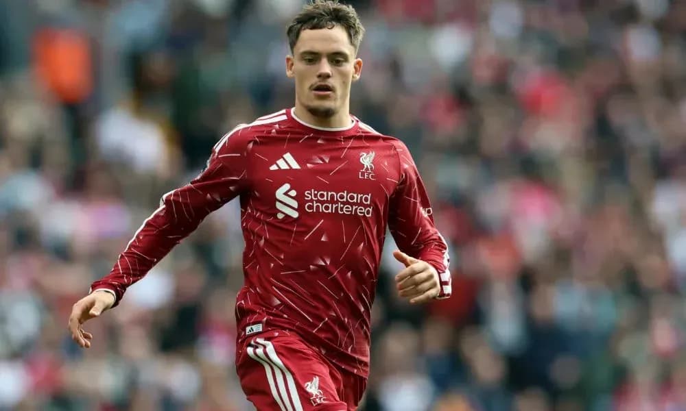 Player in red Liverpool kit running on the pitch Player in red Liverpool kit running on the pitch