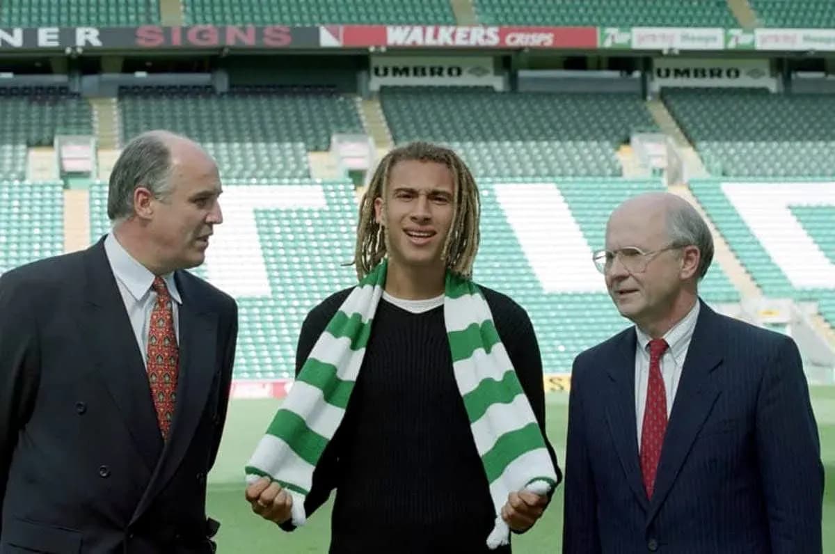 New player holding scarf at club announcement event New player holding scarf at club announcement event