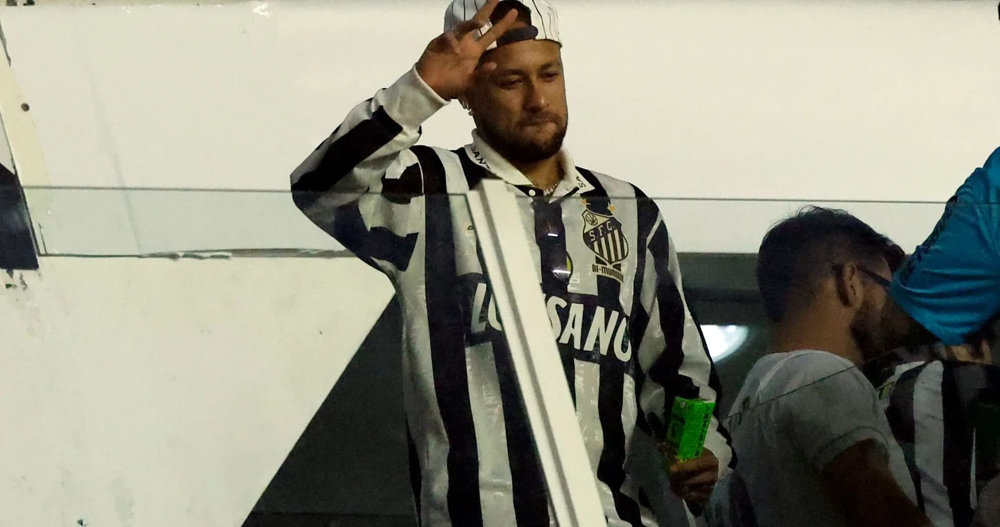 Fan waving from the stands wearing Santos jersey Fan waving from the stands wearing Santos jersey