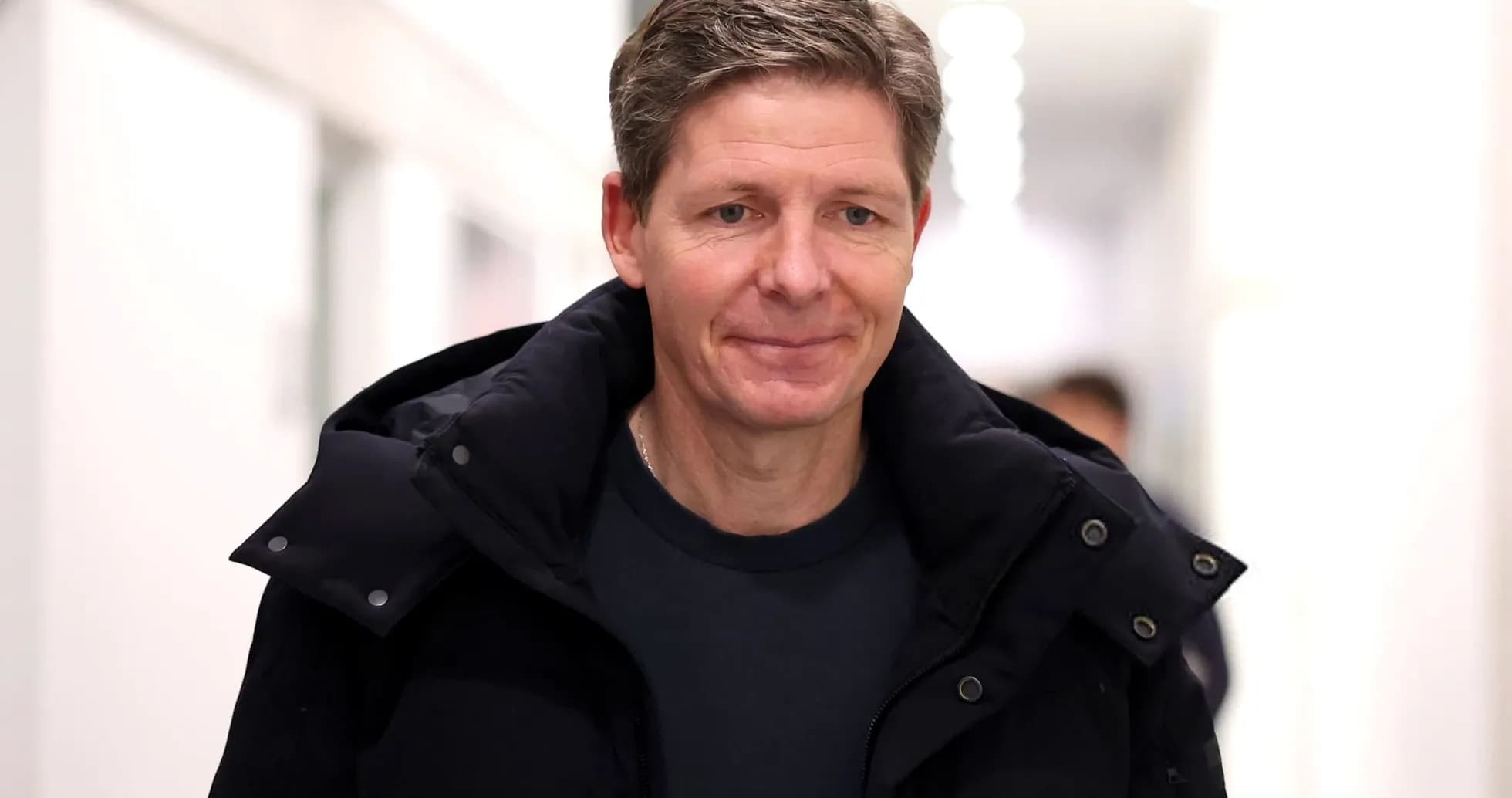 Man walking in a corridor wearing a dark coat Man walking in a corridor wearing a dark coat