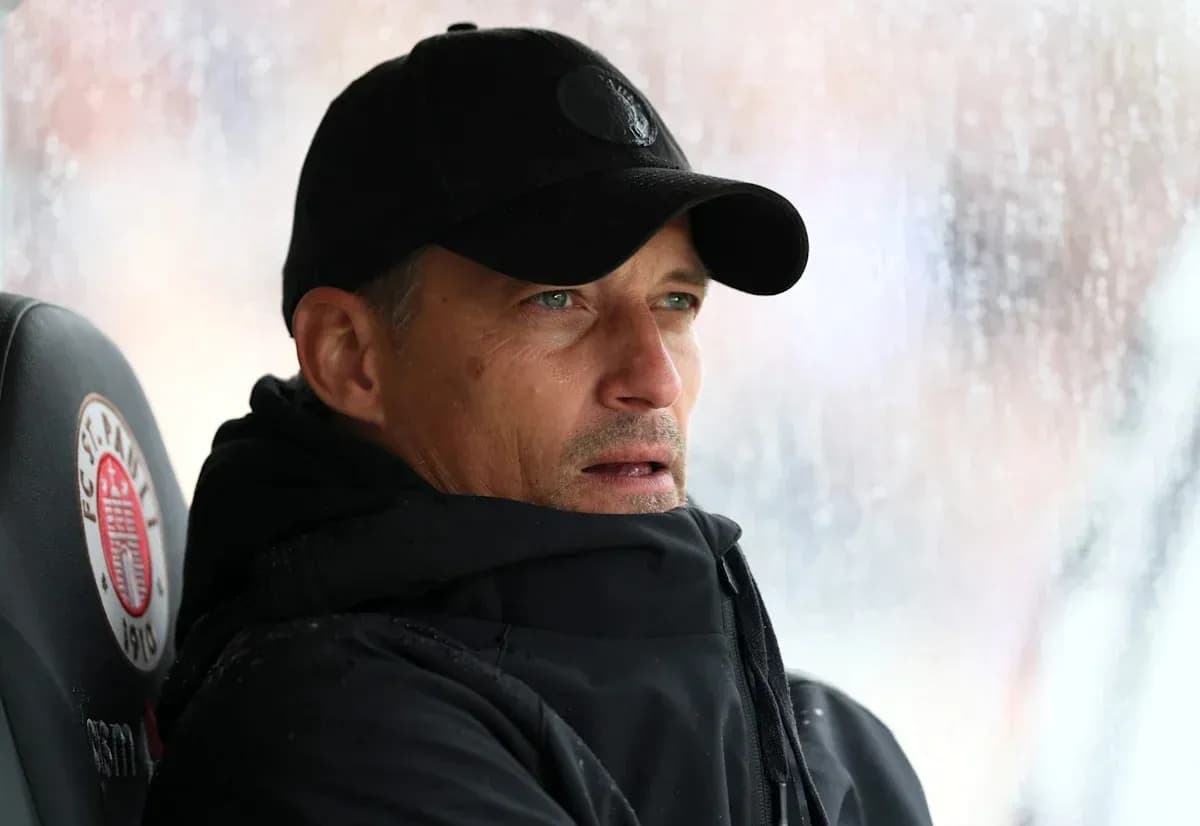 Coach observing from the sidelines in rainy weather Coach observing from the sidelines in rainy weather