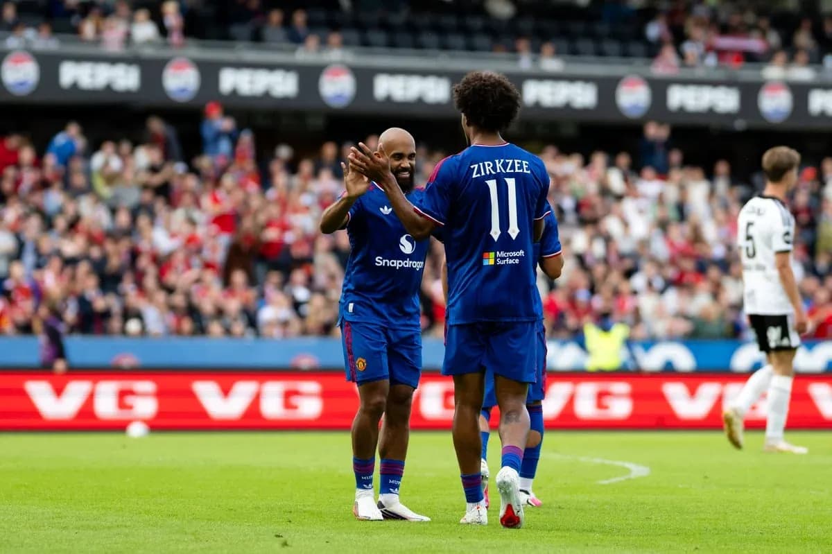 Two players celebrating on the field during match Two players celebrating on the field during match