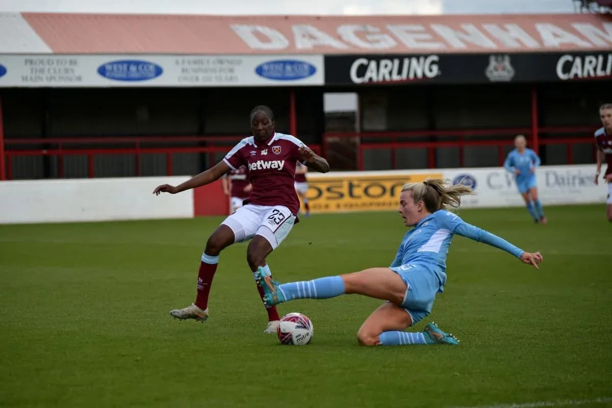 West Ham player tackling Manchester City player West Ham player tackling Manchester City player