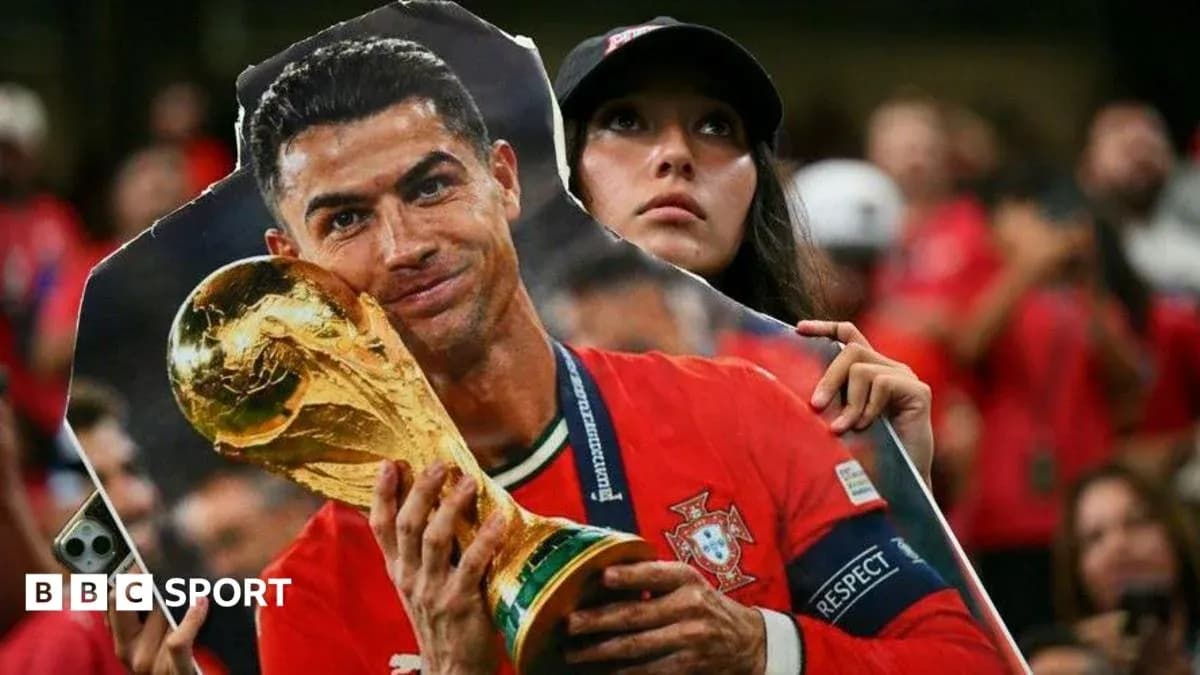 Fan holding a cutout of player with trophy Fan holding a cutout of player with trophy