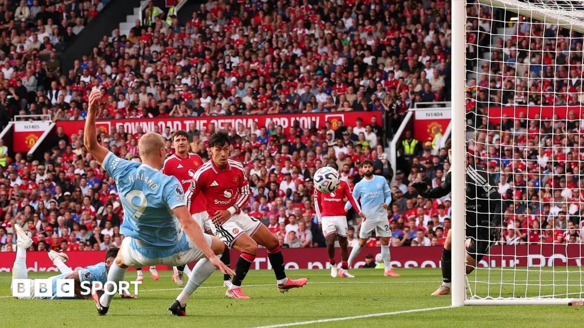 Player striking ball during Manchester derby match Player striking ball during Manchester derby match