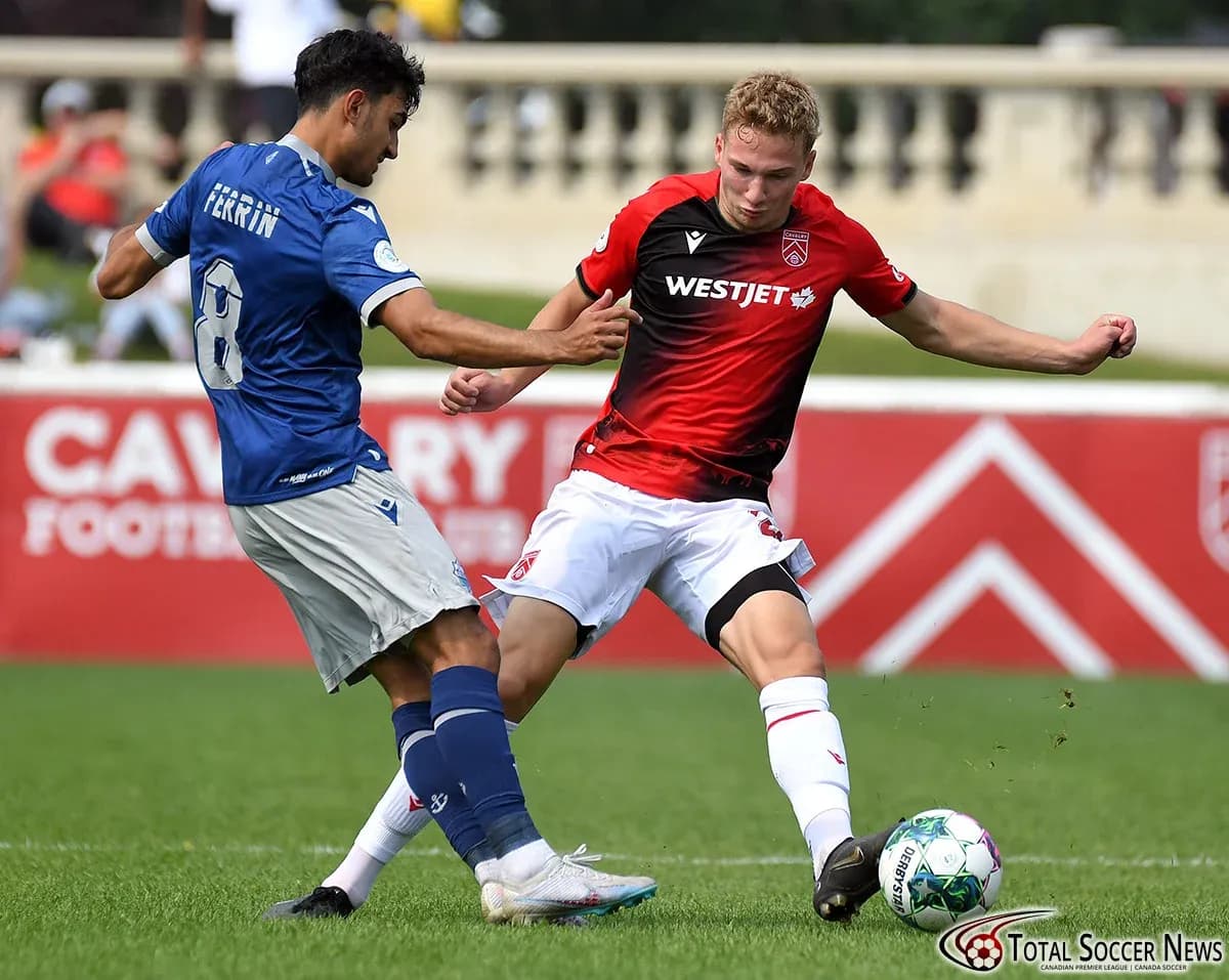 Cavalry FC player tackling HFX Wanderers FC player Cavalry FC player tackling HFX Wanderers FC player