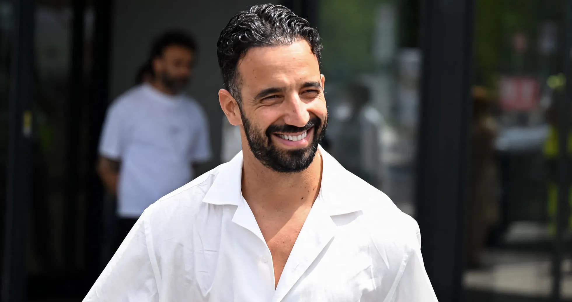 Man smiling while wearing a white shirt outdoors Man smiling while wearing a white shirt outdoors
