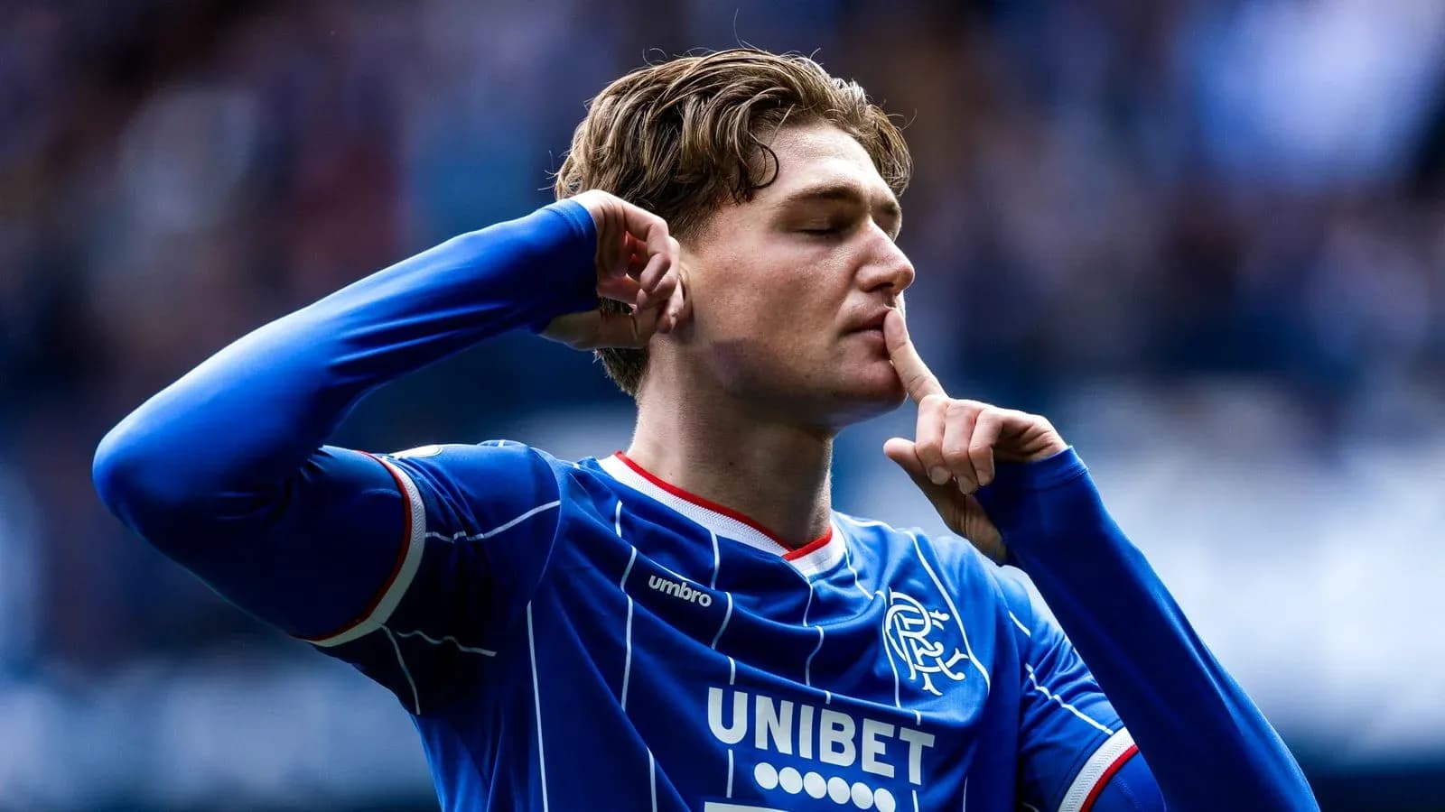Player celebrating with a shushing gesture after scoring Player celebrating with a shushing gesture after scoring