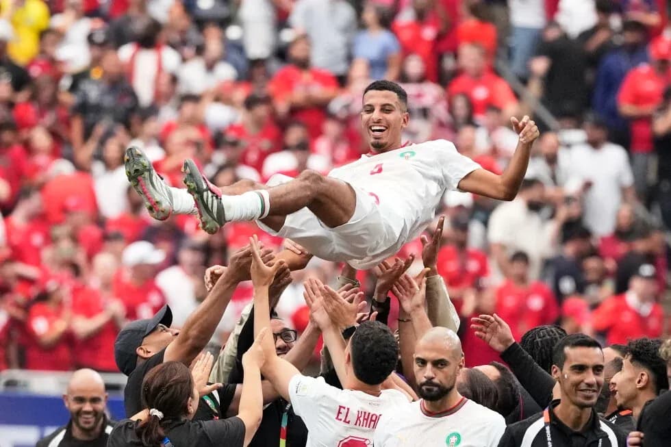 Player celebrating with fans after match victory Player celebrating with fans after match victory