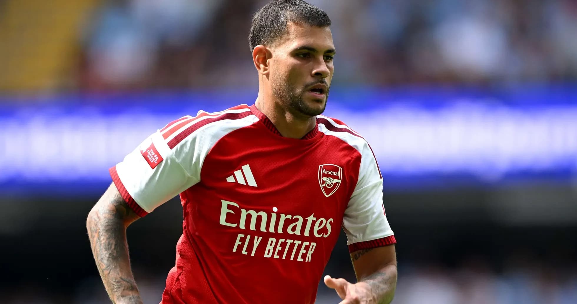 Arsenal player running during Premier League match Arsenal player running during Premier League match