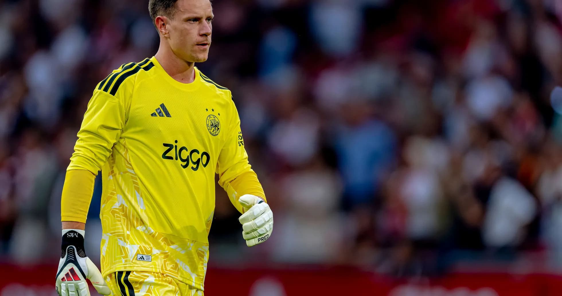 Goalkeeper in yellow kit walking on the pitch Goalkeeper in yellow kit walking on the pitch