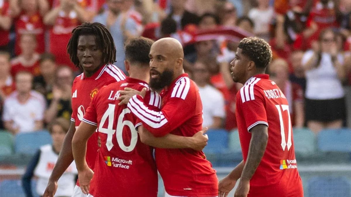 Manchester United players celebrating a goal together Manchester United players celebrating a goal together