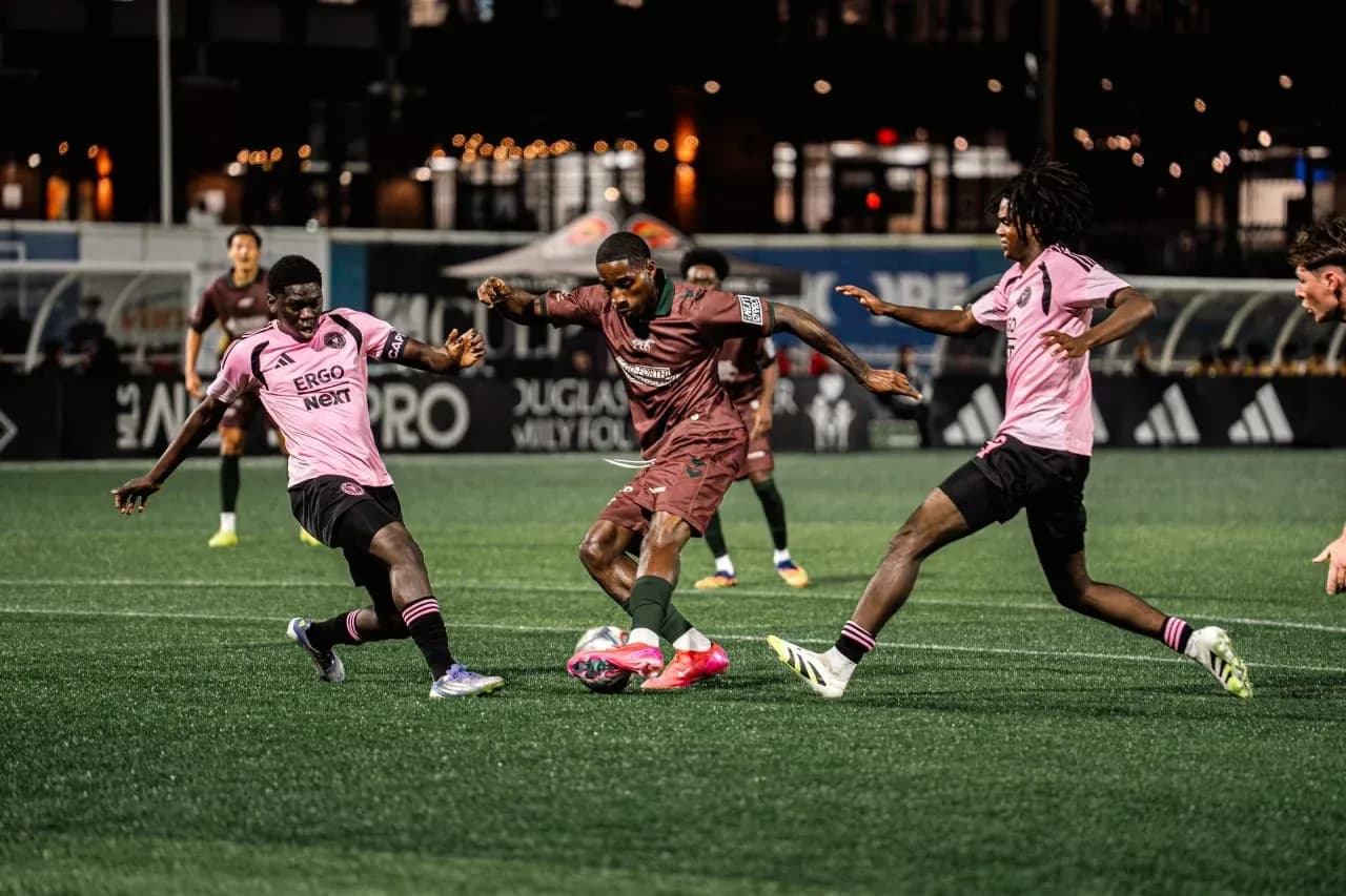 Players competing for the ball in MLS Next Pro match Players competing for the ball in MLS Next Pro match