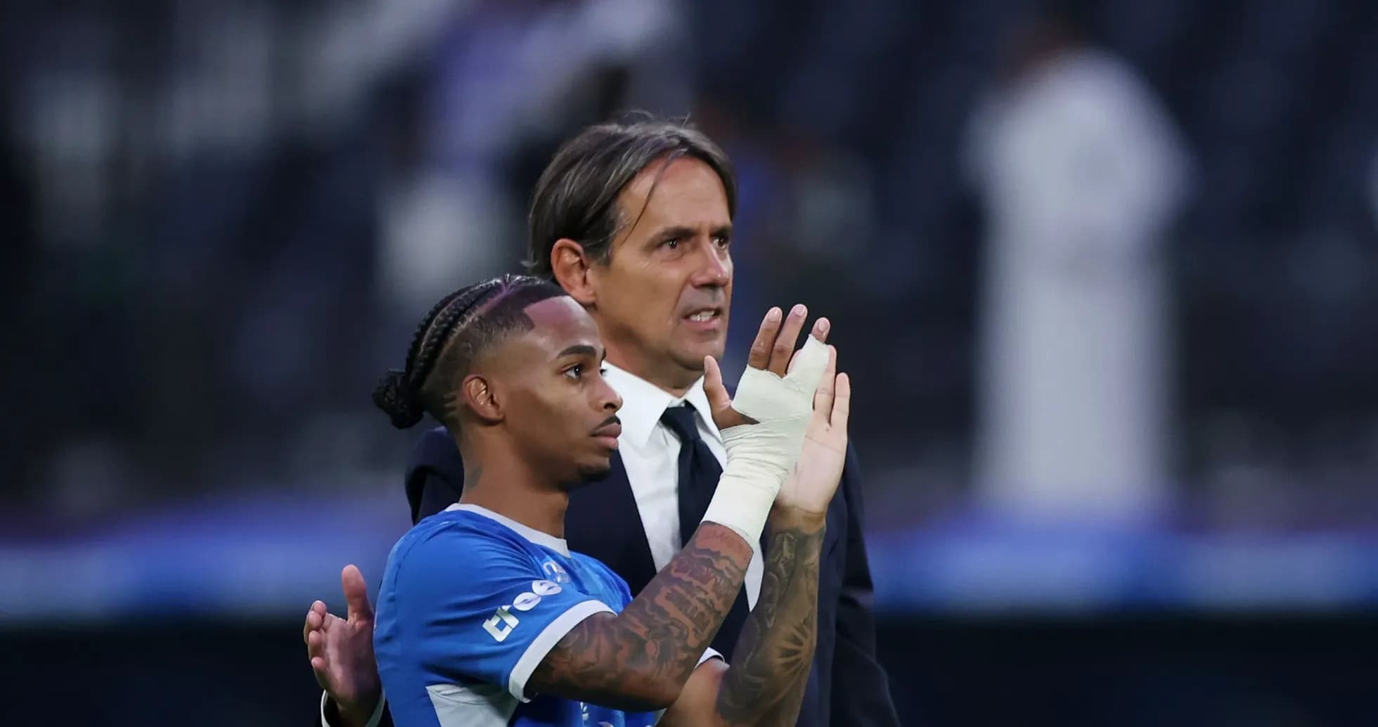 Player and coach interacting after match conclusion Player and coach interacting after match conclusion