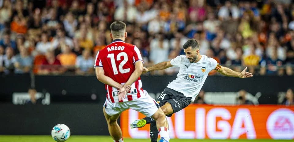 Valencia player shooting during La Liga match Valencia player shooting during La Liga match