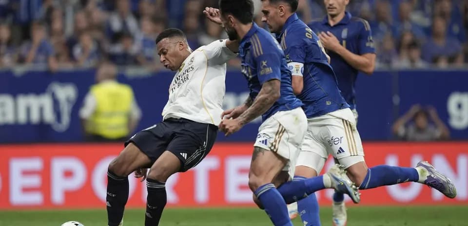 Mbappe challenged by Oviedo players during match Mbappe challenged by Oviedo players during match
