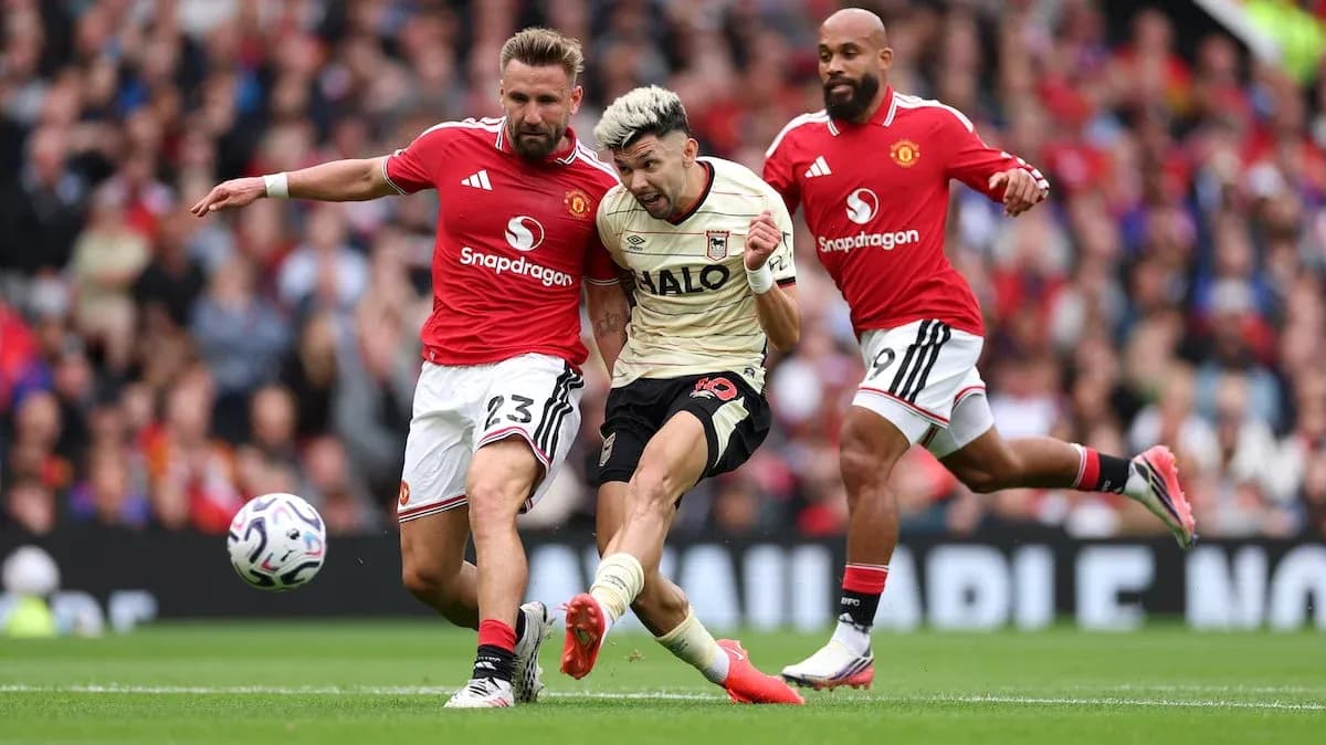 Manchester United players tackling Ipswich forward Manchester United players tackling Ipswich forward