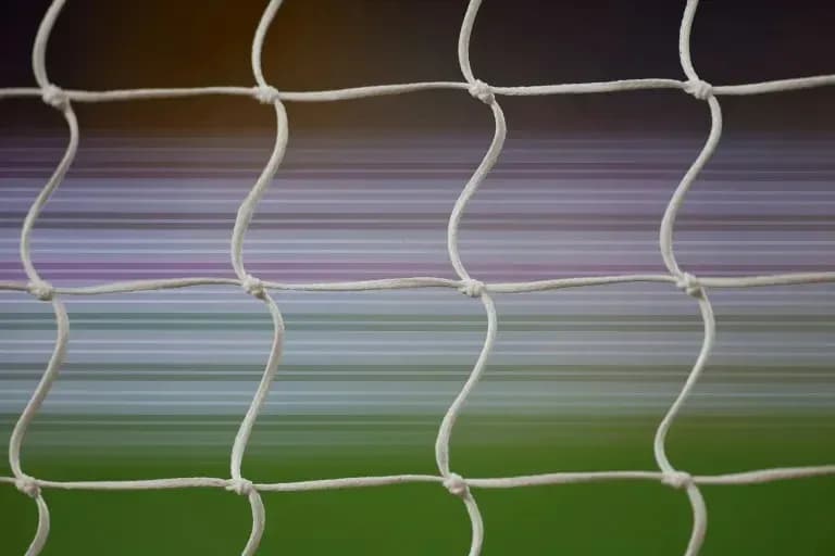 Close-up of soccer net with blurred background Close-up of soccer net with blurred background