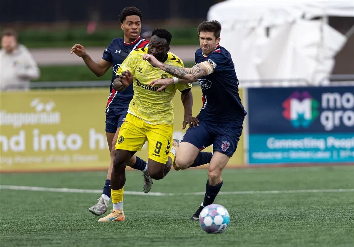 Players competing for the ball during USL match Players competing for the ball during USL match