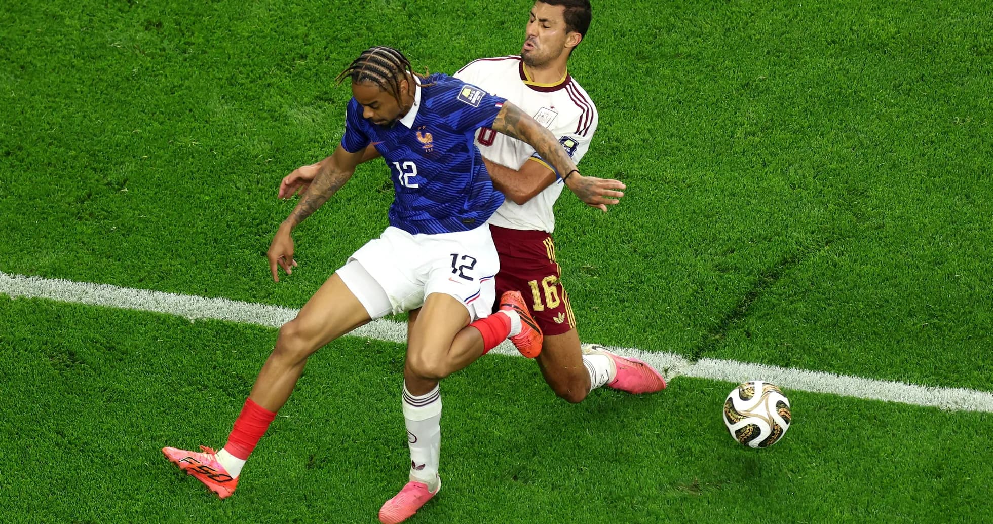 Two players competing for the ball during match Two players competing for the ball during match