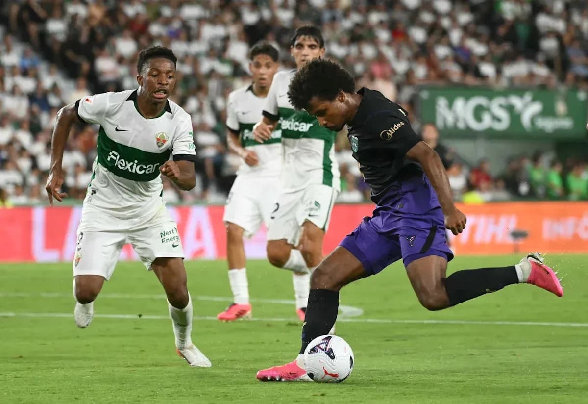 Player dribbling the ball during a football match Player dribbling the ball during a football match