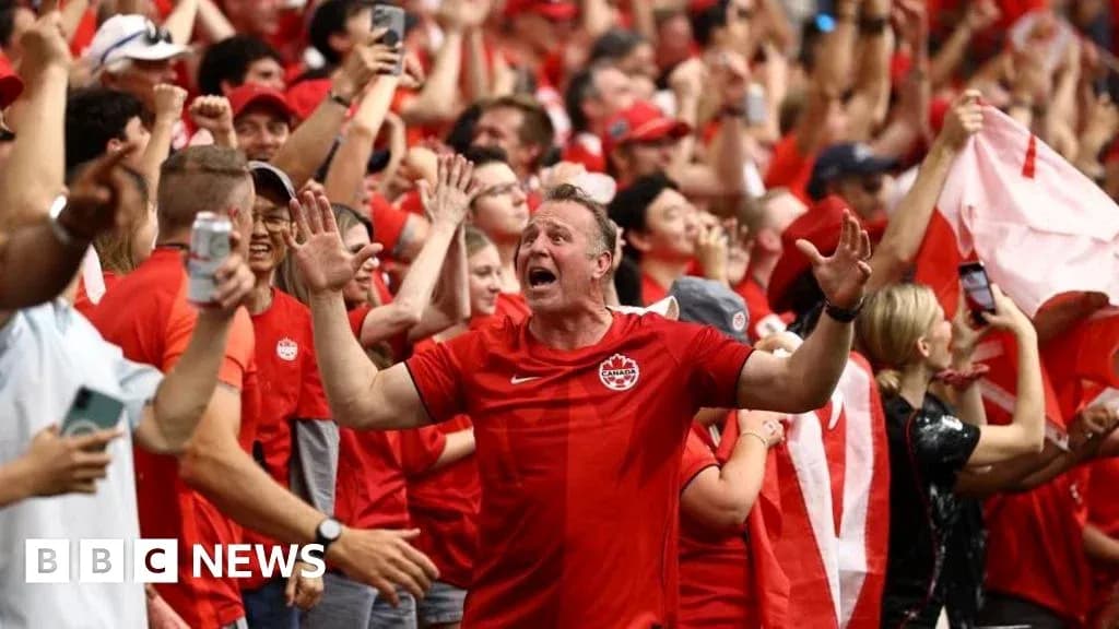Fans celebrating in red during a sports event Fans celebrating in red during a sports event