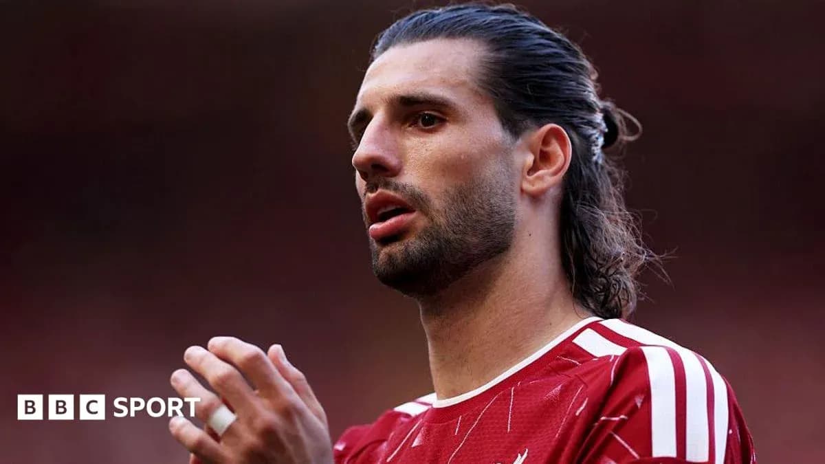 Player with long hair in red jersey during match Player with long hair in red jersey during match