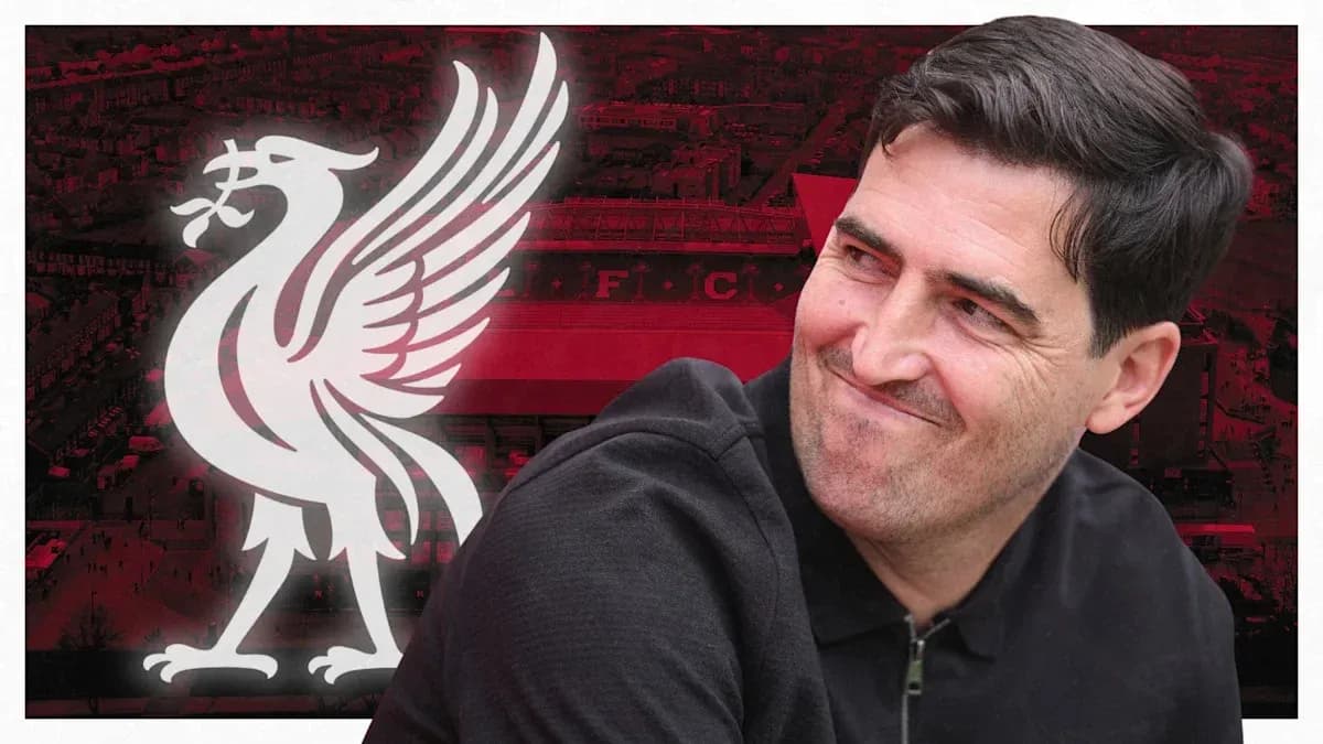 Man smiling in front of Liverpool FC logo Man smiling in front of Liverpool FC logo