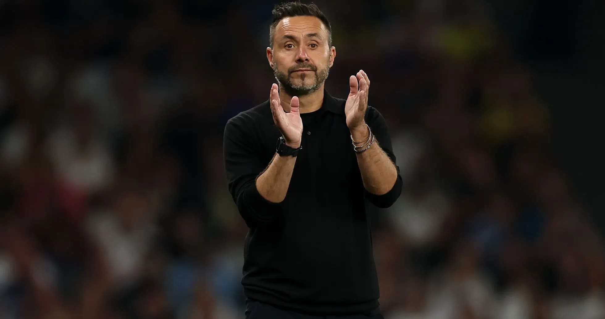 Manager applauding during a football match Manager applauding during a football match