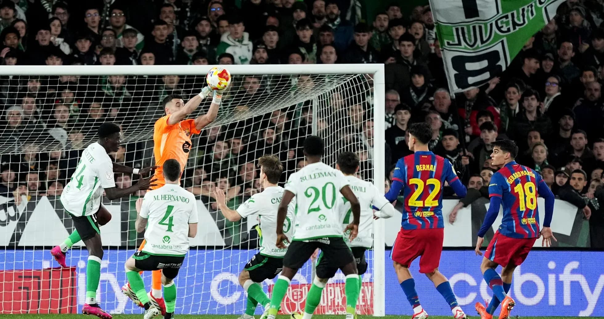 Goalkeeper catching ball during intense match action Goalkeeper catching ball during intense match action