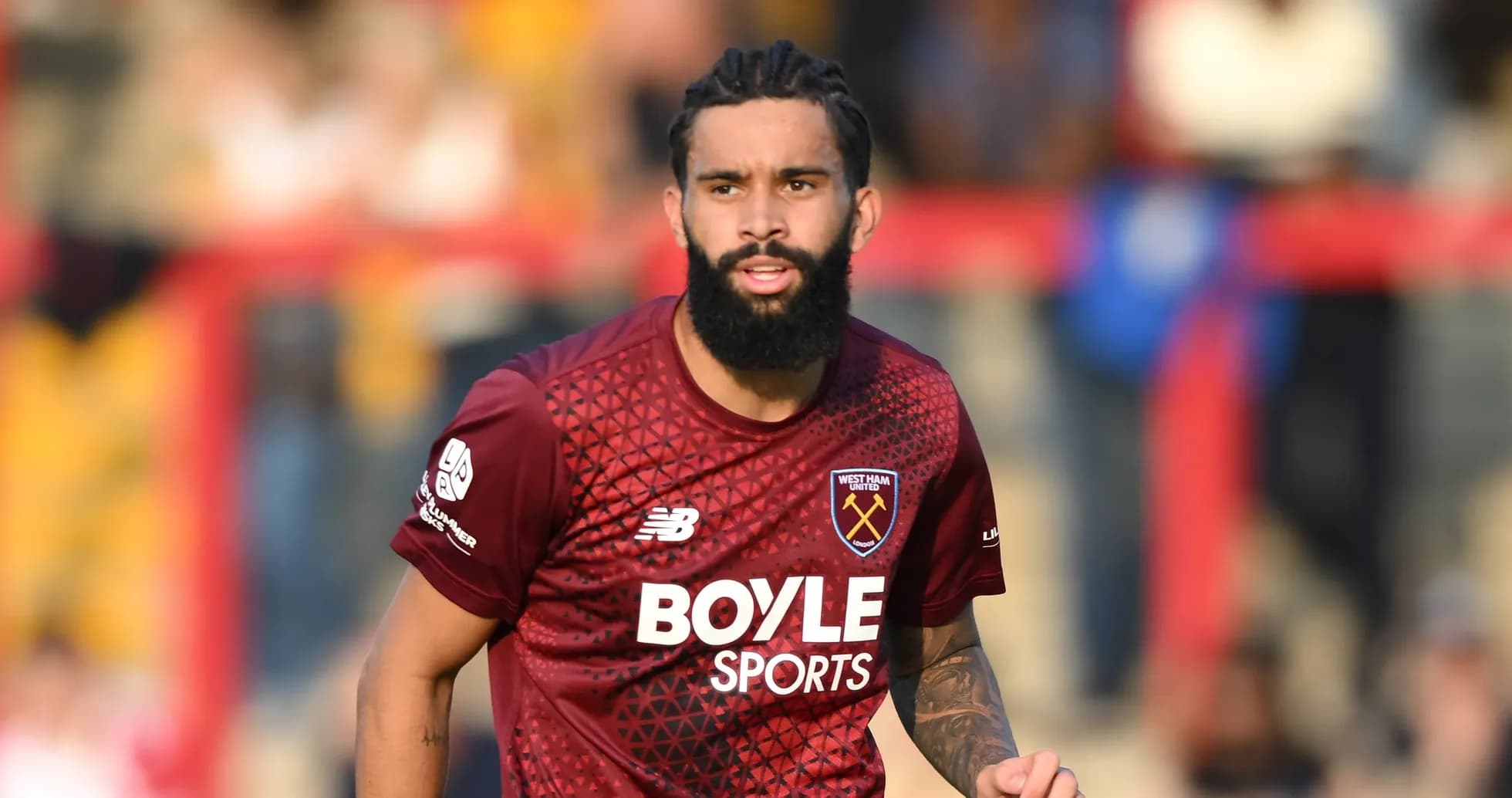 Player wearing West Ham United jersey on field Player wearing West Ham United jersey on field