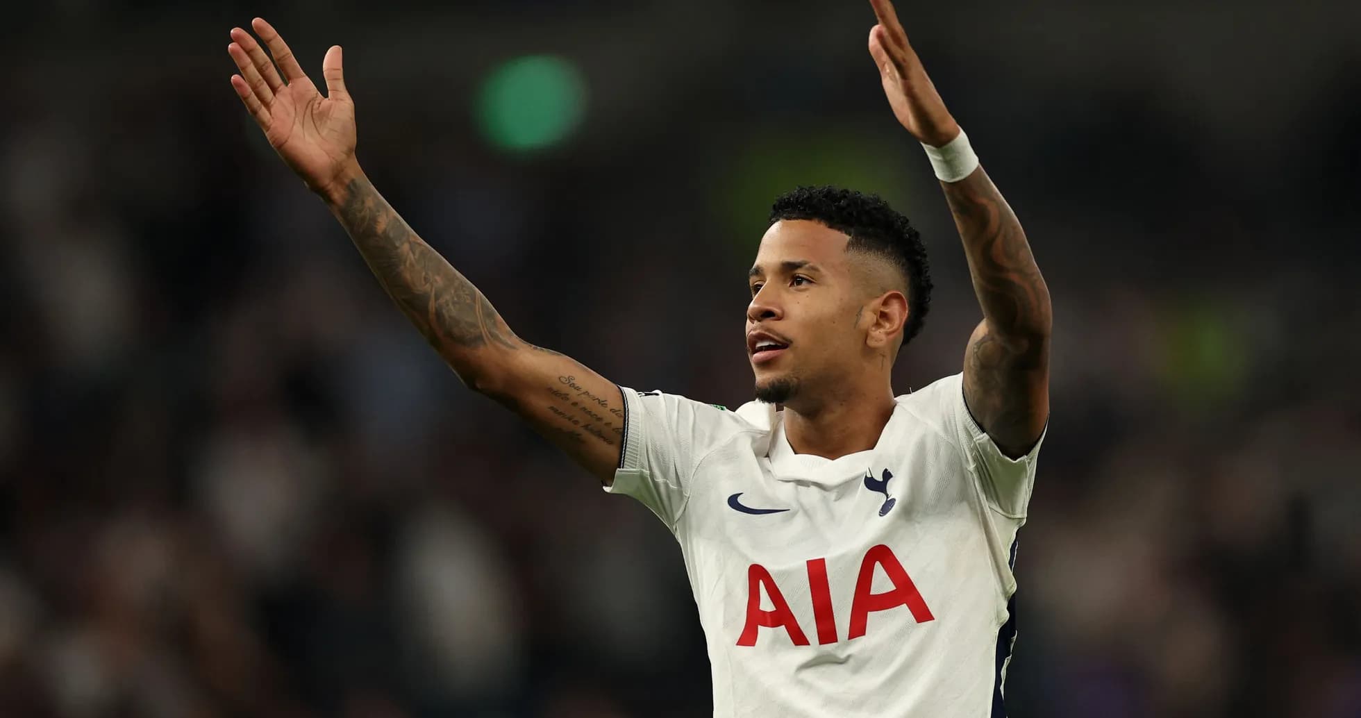 Player celebrating with arms raised during match Player celebrating with arms raised during match