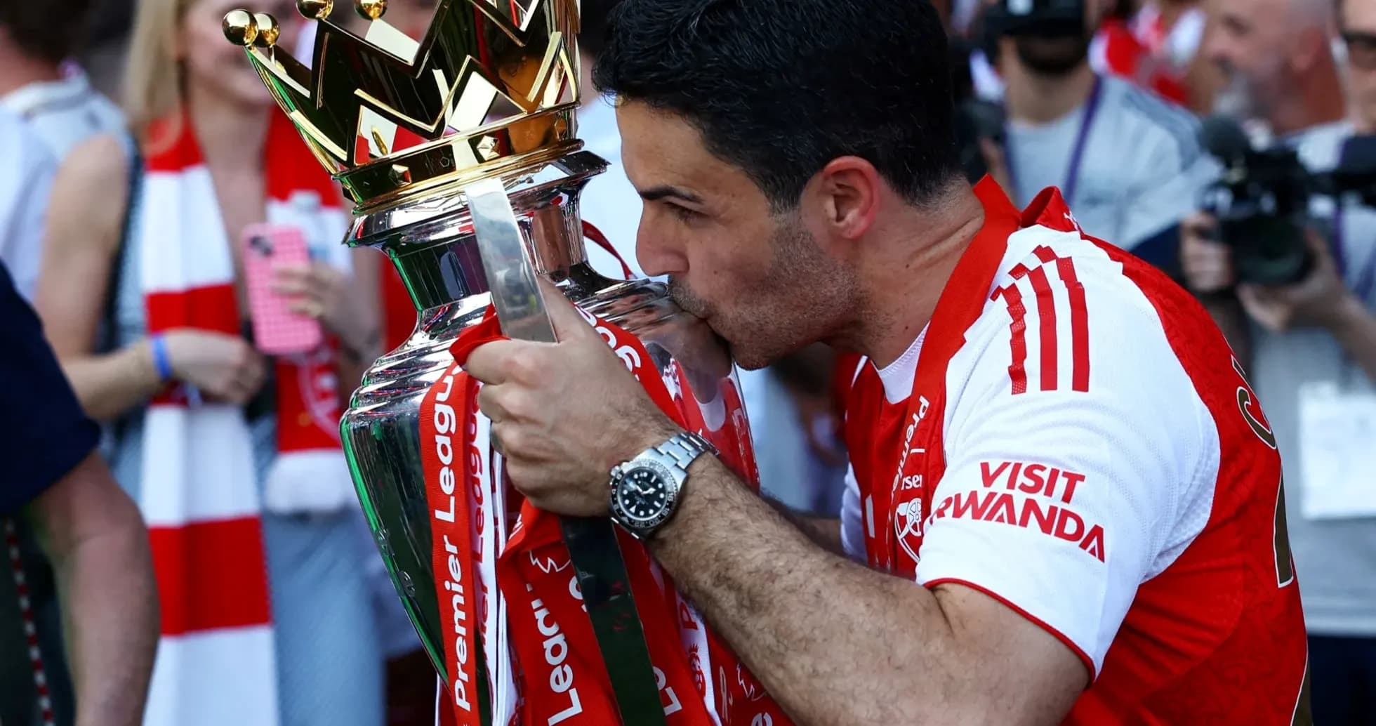 Manager kissing Premier League trophy in celebration Manager kissing Premier League trophy in celebration