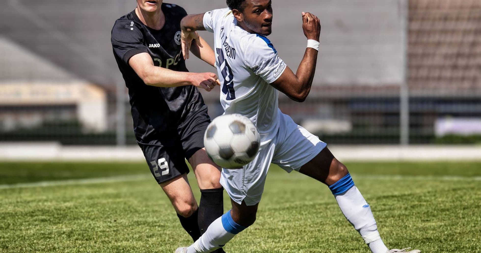 Player competing for the ball during Oberliga match Player competing for the ball during Oberliga match