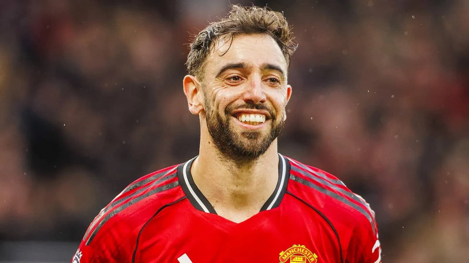 Football player smiling in Manchester United jersey Football player smiling in Manchester United jersey