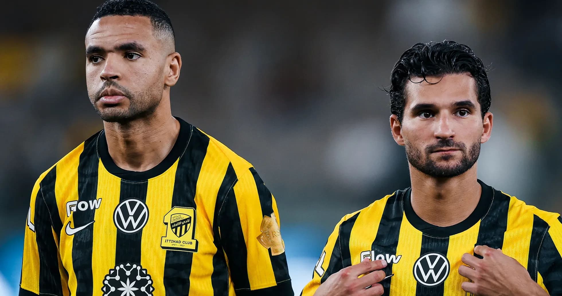 Two players in yellow and black jerseys standing together Two players in yellow and black jerseys standing together