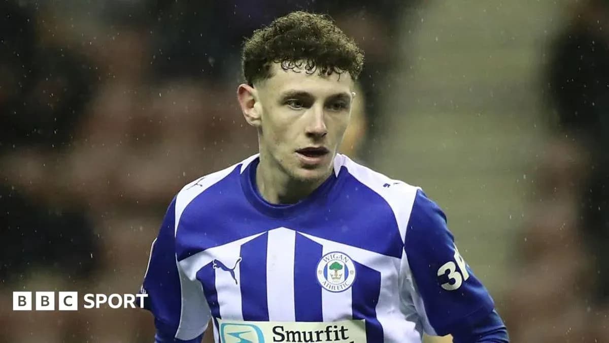 Player wearing Wigan Athletic jersey on the field Player wearing Wigan Athletic jersey on the field
