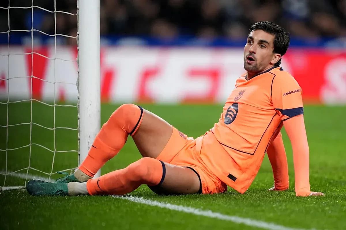 Goalkeeper sitting on the ground near the goalpost Goalkeeper sitting on the ground near the goalpost