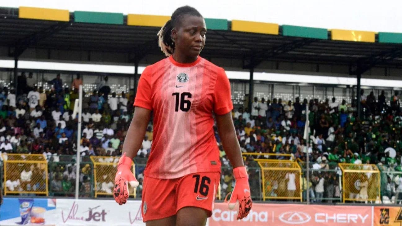 Goalkeeper in red jersey walking on the field Goalkeeper in red jersey walking on the field