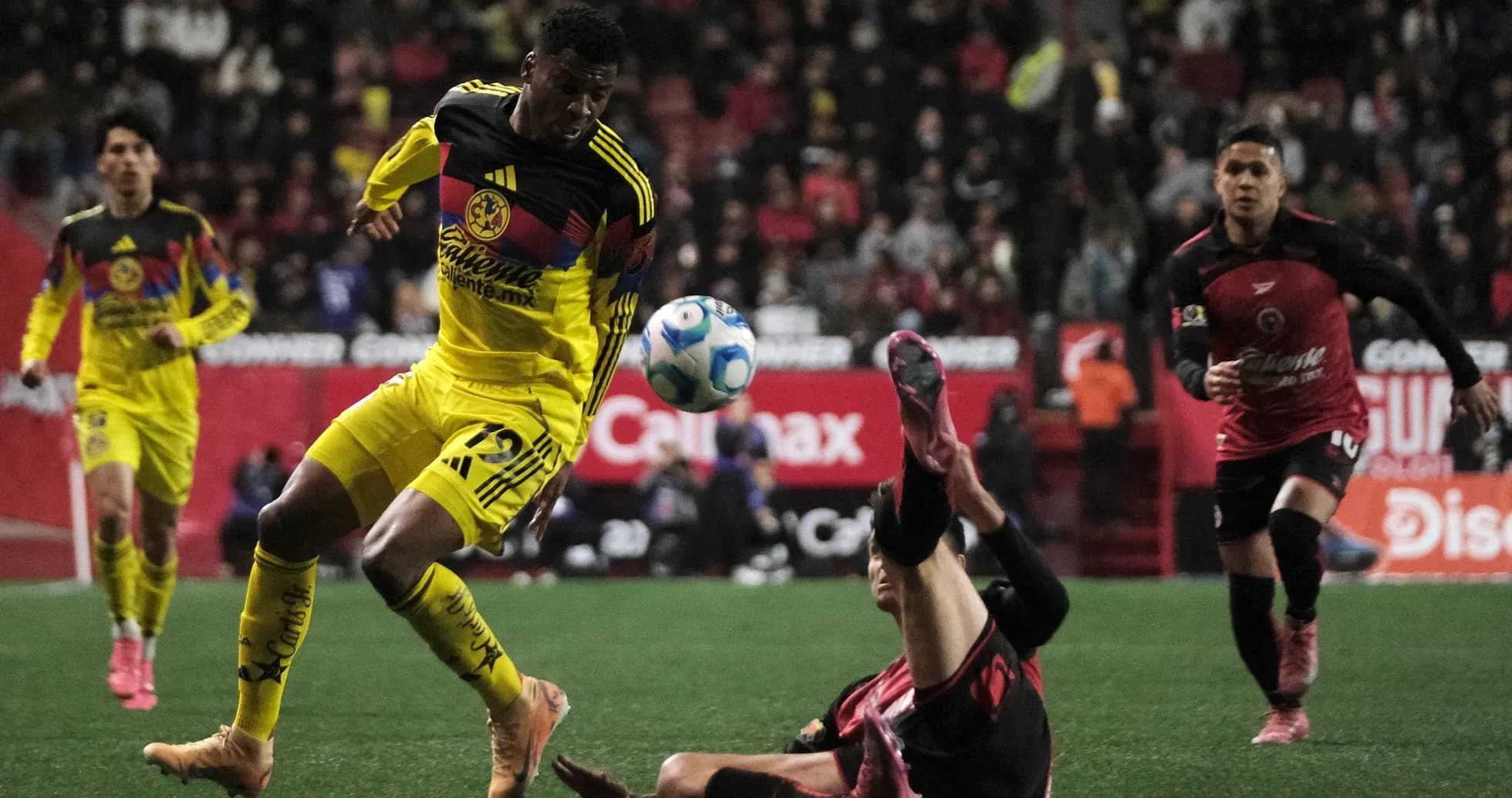 Club America player dribbling past Club Tijuana defender Club America player dribbling past Club Tijuana defender