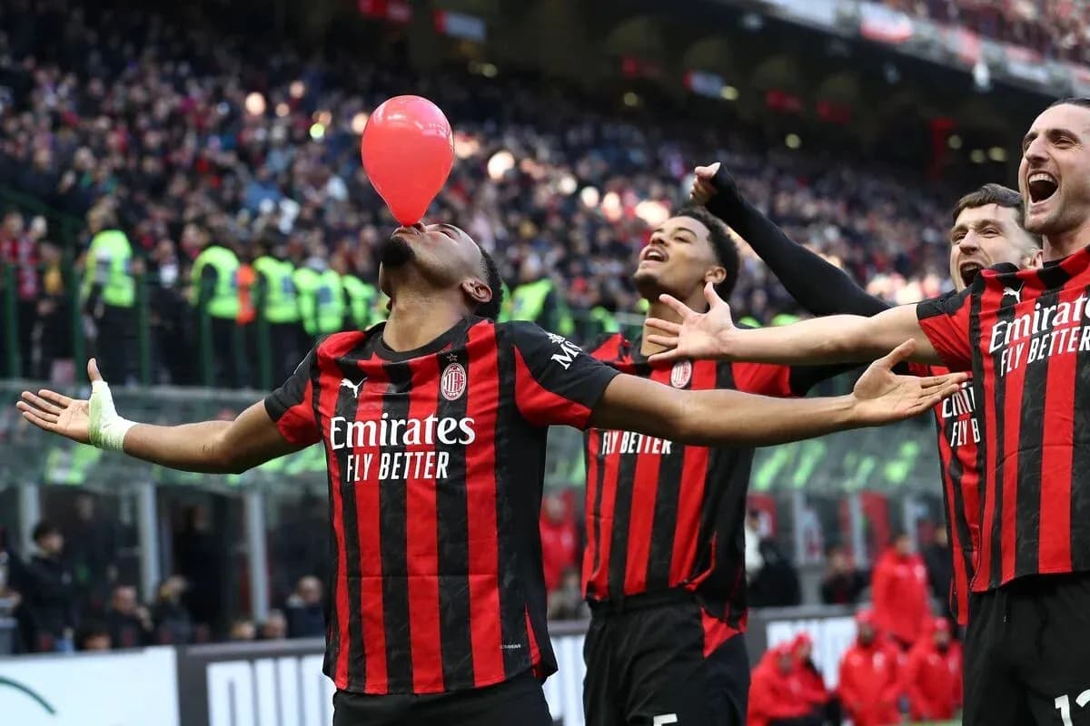 AC Milan players celebrating with a balloon AC Milan players celebrating with a balloon