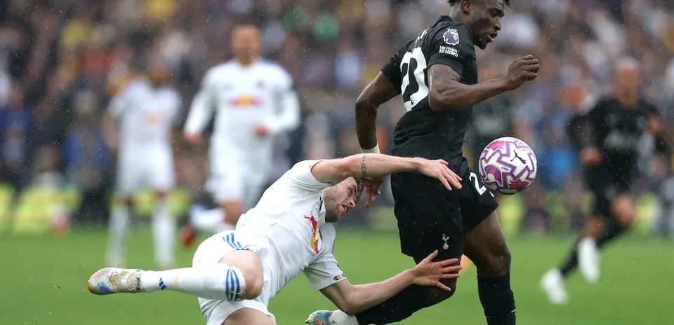 Player evading tackle during Premier League match Player evading tackle during Premier League match
