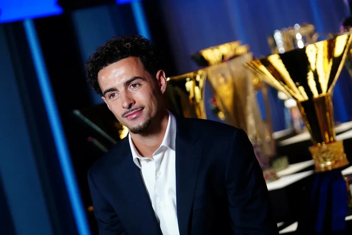 Player posing in front of trophy display Player posing in front of trophy display