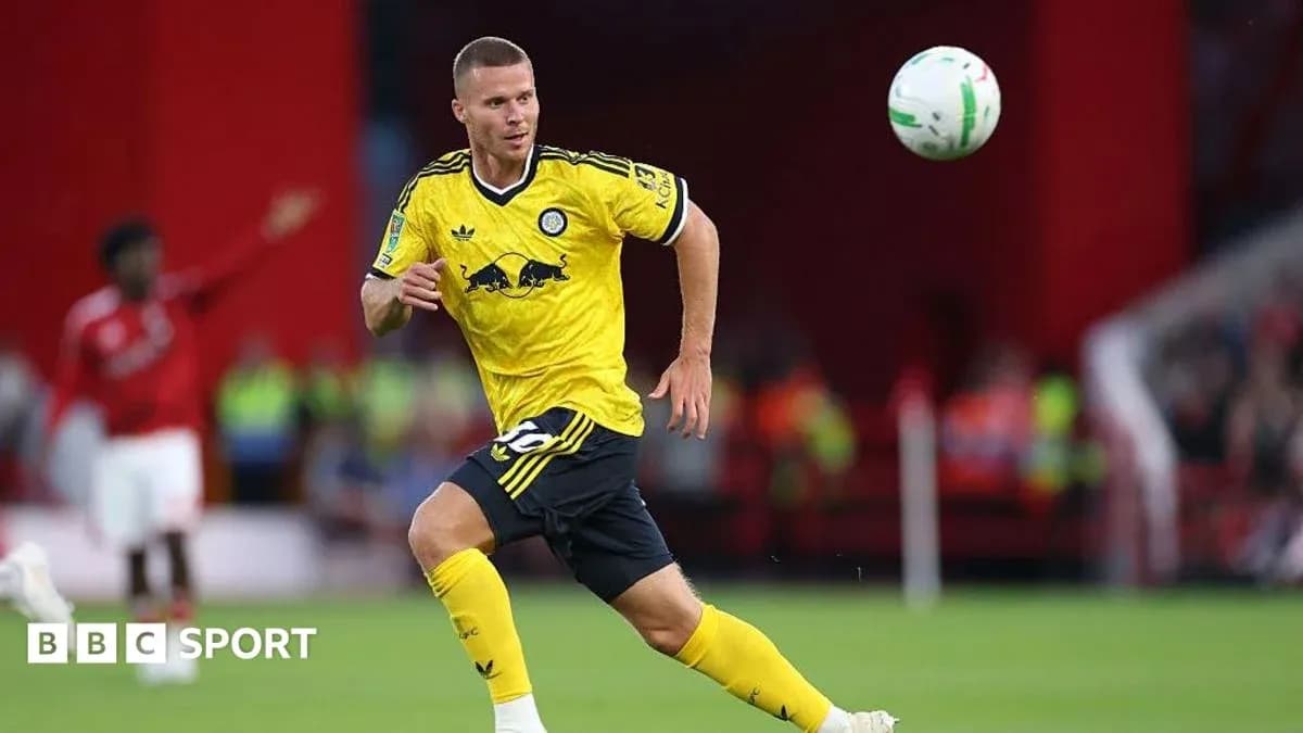 Player in yellow kit chasing a ball during match Player in yellow kit chasing a ball during match