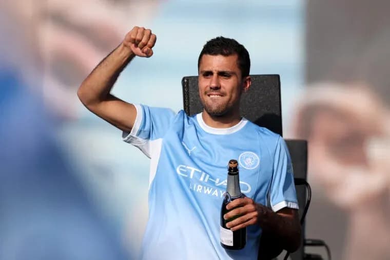 Player celebrating with champagne in team jersey Player celebrating with champagne in team jersey