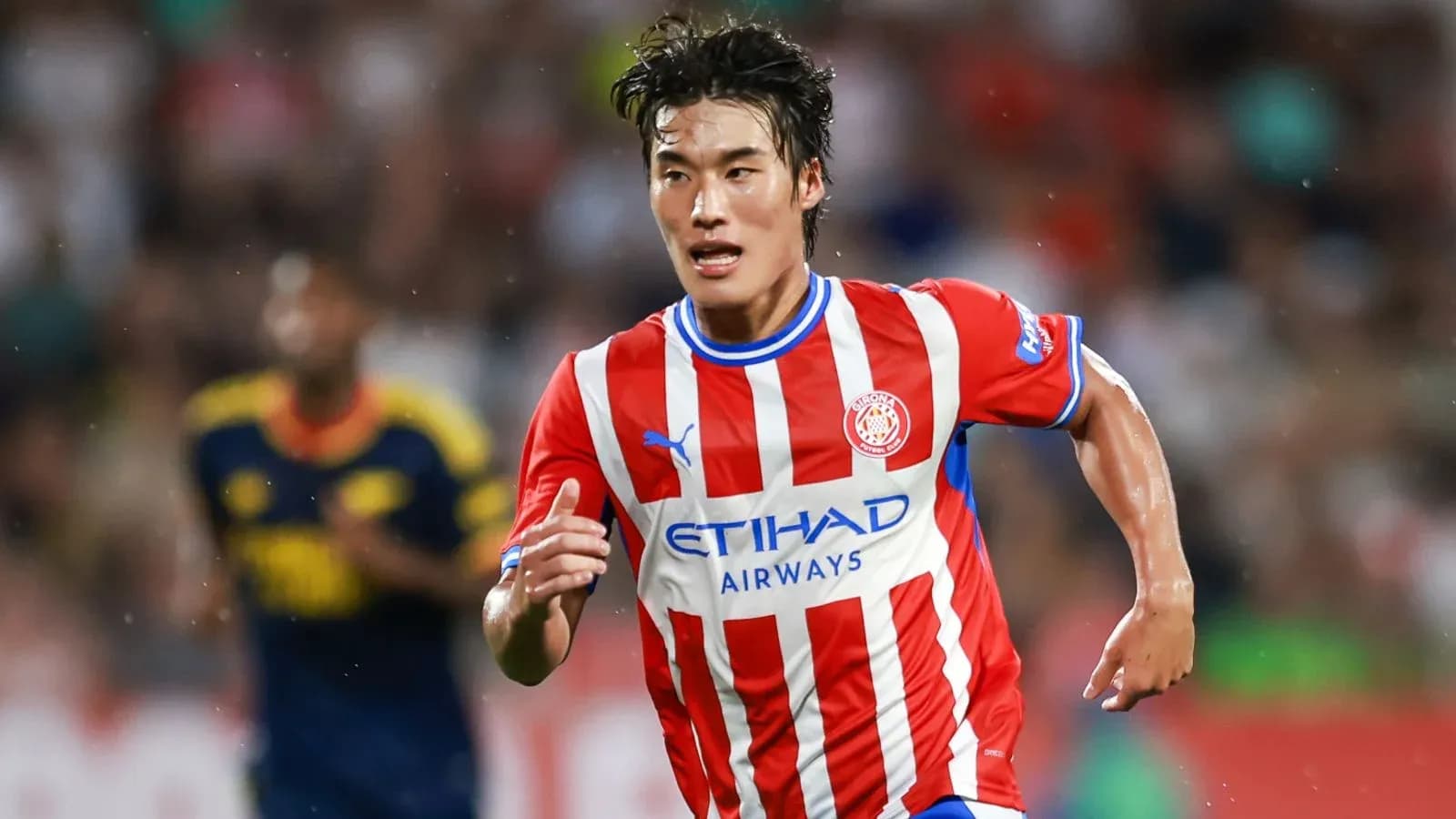 Player running with ball during match for Girona Player running with ball during match for Girona