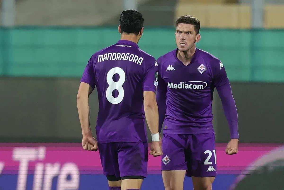 Fiorentina players celebrating during a match Fiorentina players celebrating during a match