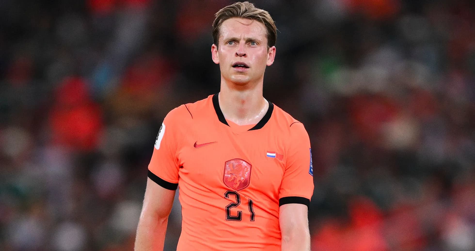 Player wearing orange jersey on the field Player wearing orange jersey on the field
