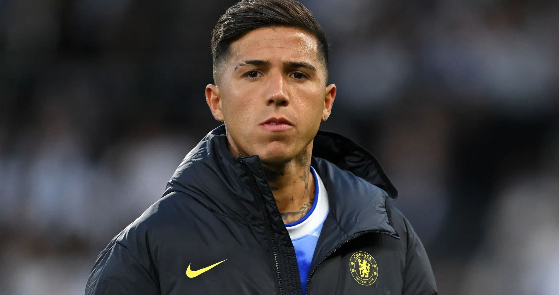 Player wearing Chelsea jacket on the sidelines Player wearing Chelsea jacket on the sidelines