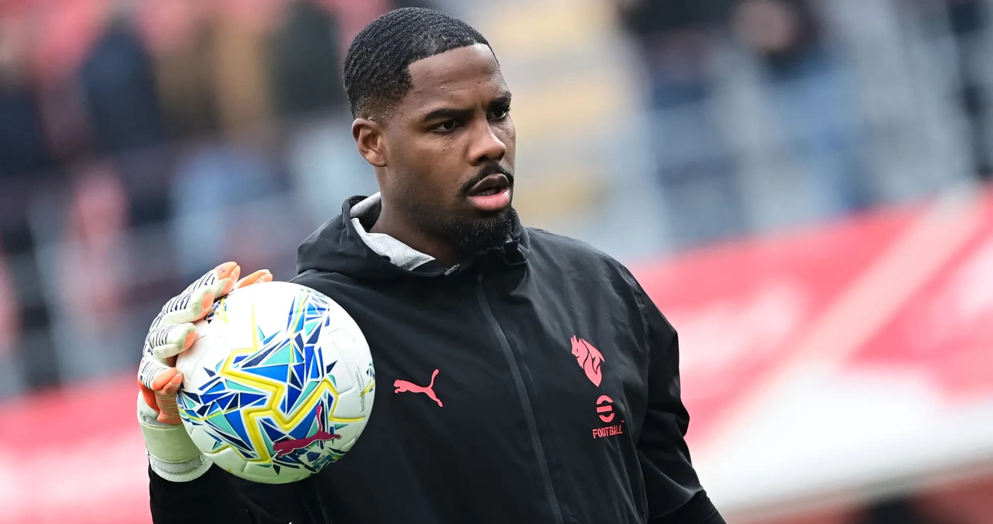 Goalkeeper holding a ball during warm-up Goalkeeper holding a ball during warm-up
